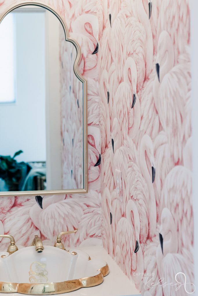 the collins off main bathroom with pink flamingo wallpaper and gold accents