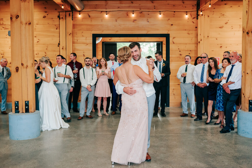Bride and groom holding hands and dancing at wedding reception at Robin Hills