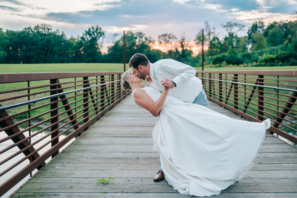 Bride and groom kissing with a dip at Robin Hills in Michigan