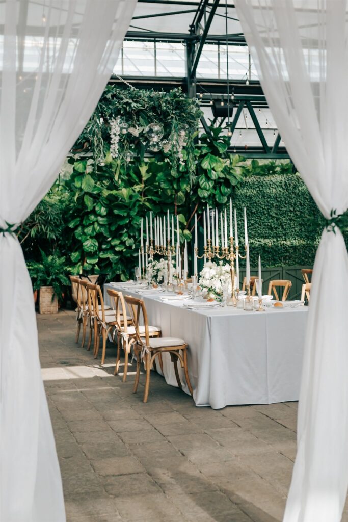 Wedding reception at Planterra Conservatory in Michigan, with white candles and linens