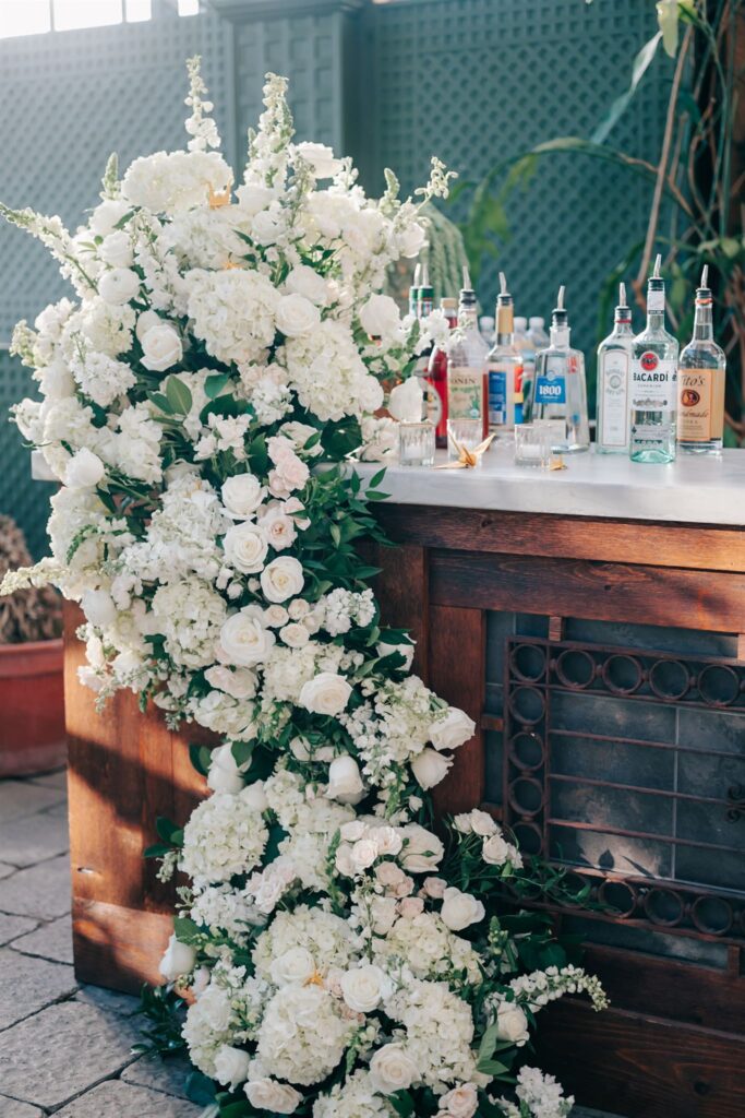 Beautiful white florals on the wedding reception bar at Planterra Conservatory