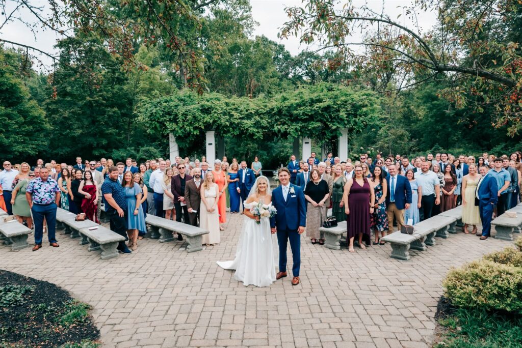 Bride, groom and wedding guests after wedding ceremony at Wellers Carriage House in Michigan