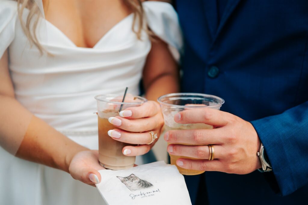 Bride and groom with cat napkin at wedding at Wellers Carriage House in Southeastern Michigan