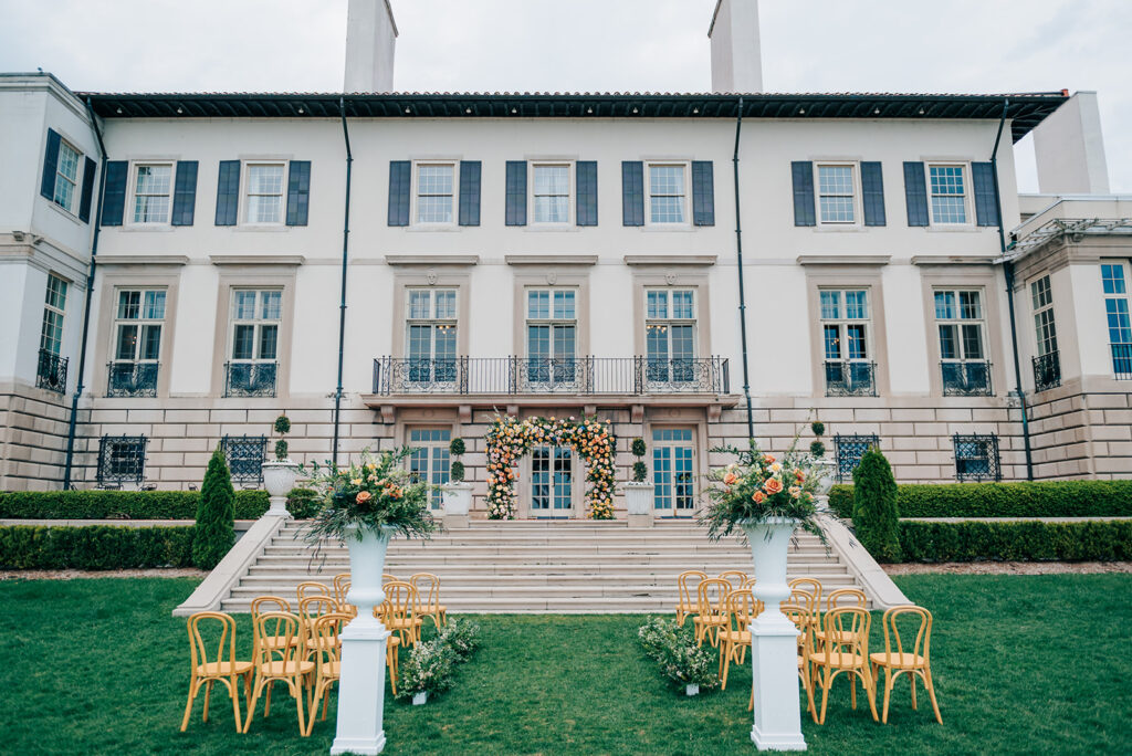 Exterior outside view of wedding ceremony with colorful florals at The War Memorial in Detroit Michigan