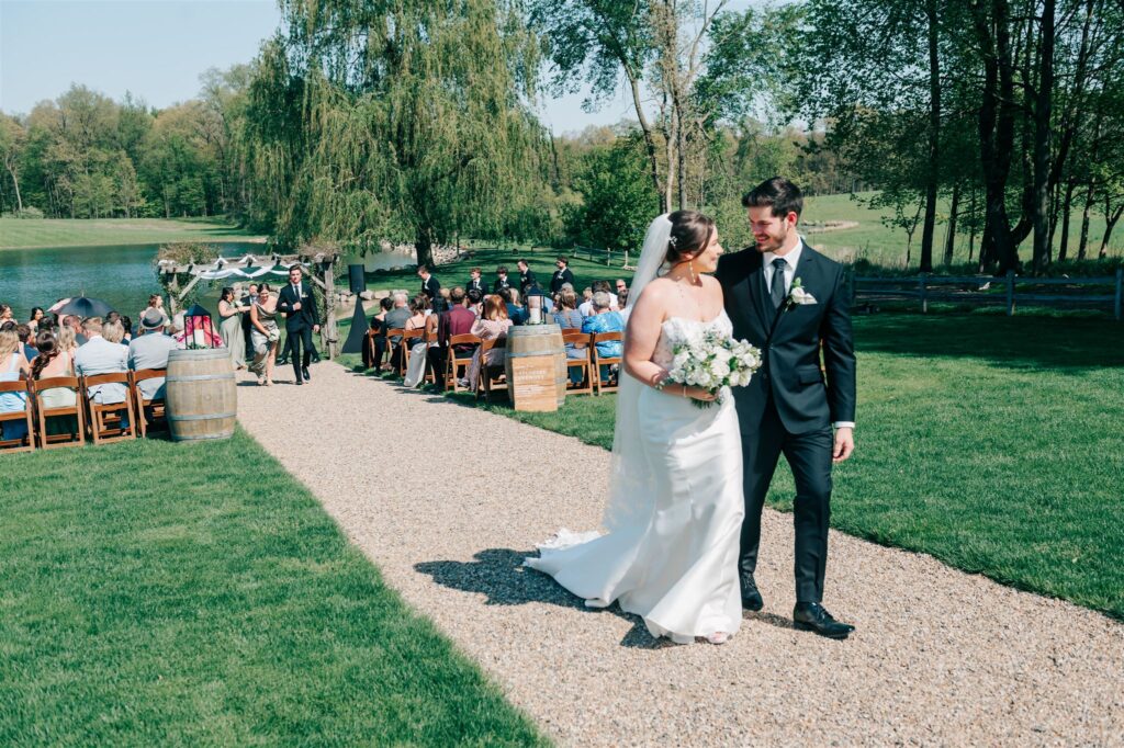 Bride and groom exiting ceremony at wedding at Westers Vineyard in Michigan