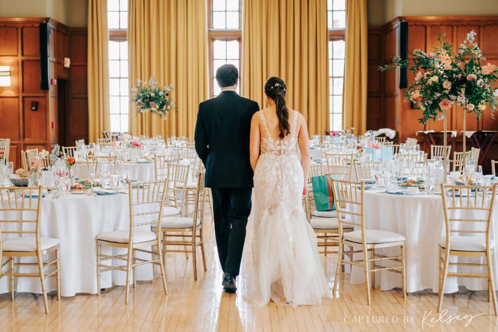 Couple walking into their wedding reception at Michigan League Ballroom