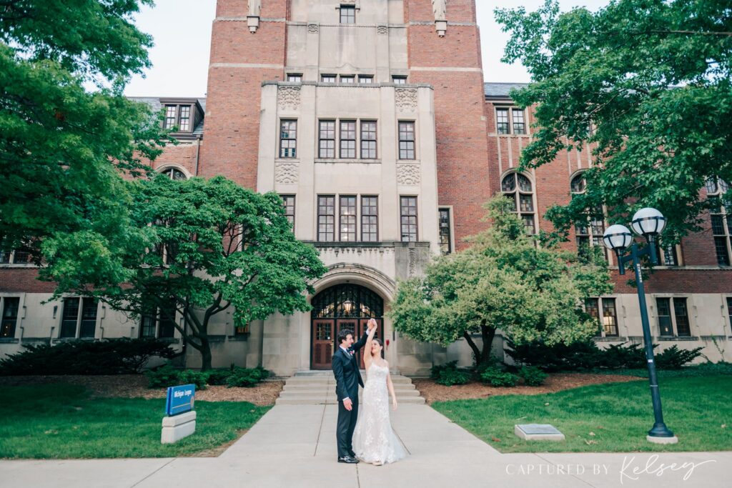 Couple holding hands for wedding photos at Michigan League