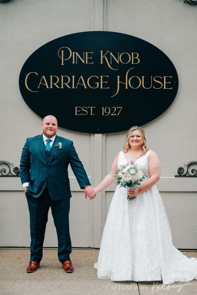 Couple standing in front of Pine Knob Carriage House