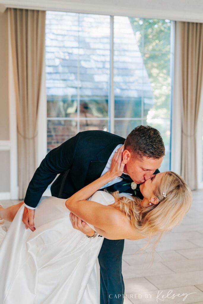 Couple kissing at reception at Pine Knob Carriage House