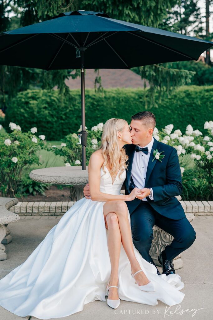 Couple kissing on the property of Pine Knob Carriage House