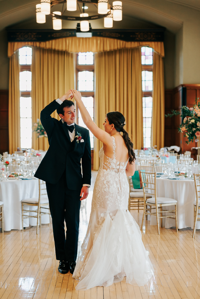 Couple holding hands in Michigan League Ballroom